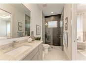 1st ensuite guest bath - Single Family Home for sale at 602 Regatta Way, Bradenton, FL 34208 - MLS Number is A4499642