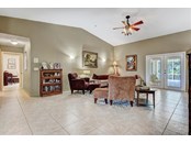Living room, French doors to pool area - Single Family Home for sale at 1518 Bel Air Star Pkwy, Sarasota, FL 34240 - MLS Number is A4506654