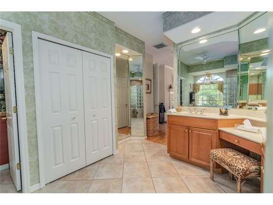 Large Double Doored Linen Closet next to Build-in fashionable 3 Way Full Length Dressing Mirror. - Single Family Home for sale at 6521 Sundew Ct, Lakewood Ranch, FL 34202 - MLS Number is A4514104