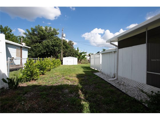 Side of house - Single Family Home for sale at 104 Portia St N, Nokomis, FL 34275 - MLS Number is A4514916
