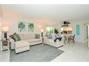 Living room with Tile Floors; East and South windows bring in natural light - Condo for sale at 450 Gulf Of Mexico Dr #B107, Longboat Key, FL 34228 - MLS Number is A4520786