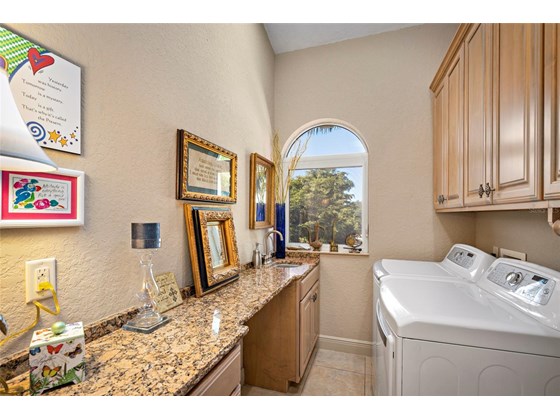 The laundry room provides plenty of space for folding and hanging all your delicates. - Single Family Home for sale at 1012 Bayview Dr, Nokomis, FL 34275 - MLS Number is A4521028