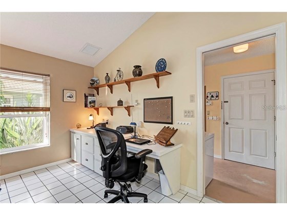 built in desk in family room area. door leads to large inside laundry with lots of storage - Single Family Home for sale at 10 Pine Ridge Way, Englewood, FL 34223 - MLS Number is N6118641