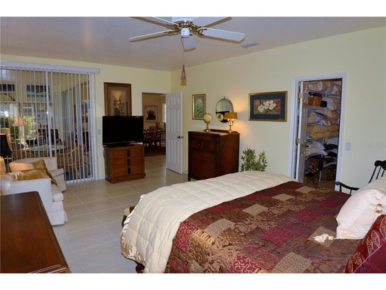 Master bedroom with slider to Florida room - Single Family Home for sale at 1609 Slate Ct, Venice, FL 34292 - MLS Number is N6119107
